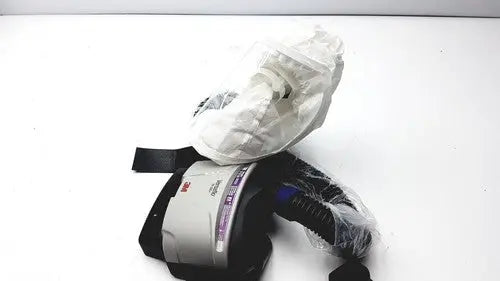 3m papr versaflo blower mx2169225 respirator mask with black straps gray housing partially wrapped in clear plastic