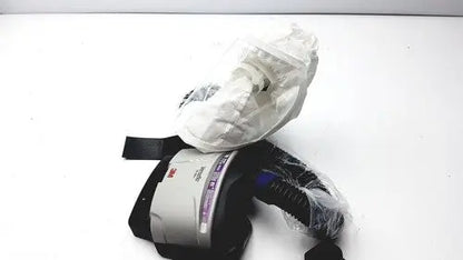 3m papr versaflo blower mx2169225 respirator mask with black straps gray housing partially wrapped in clear plastic