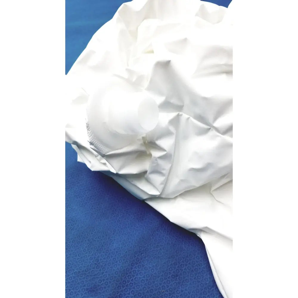 A crumpled white plastic bottle inside a white paper bag beside a 3m s-533s high durability hood with integrated head suspension