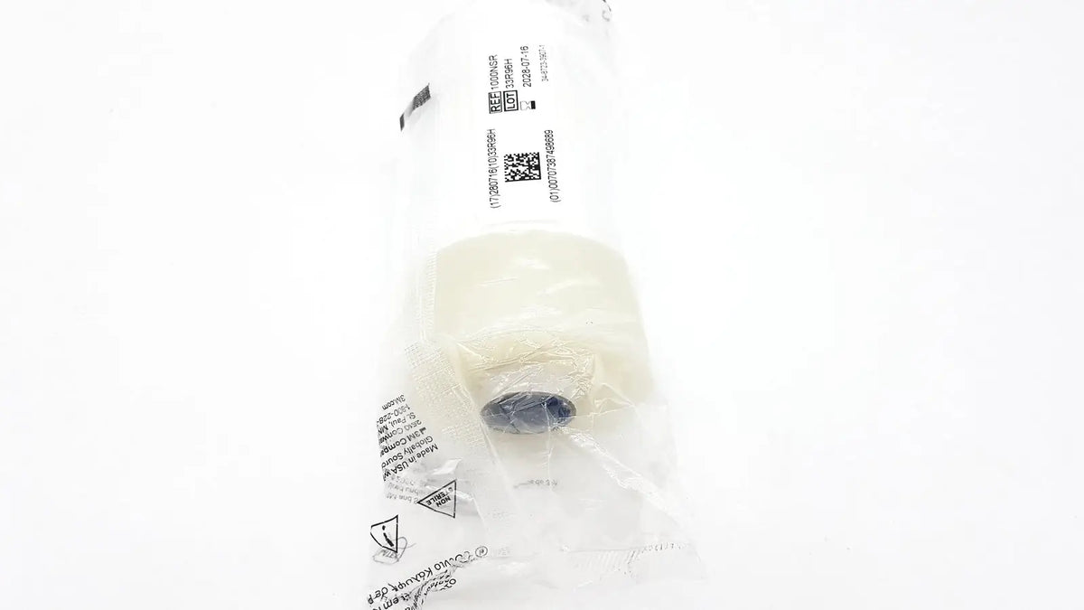 A white cylindrical filter element sealed in clear plastic packaging for 3m steri-drape roll prep drape 1000nsr