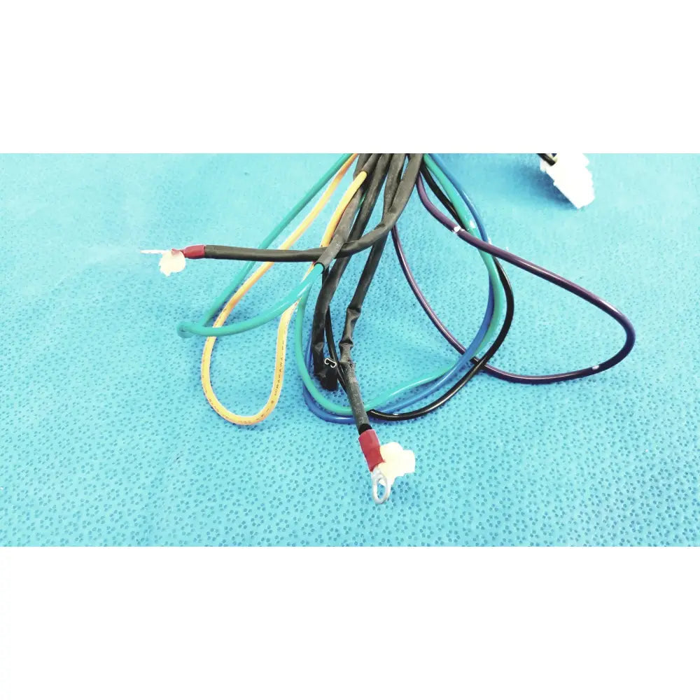 A bundle of multi-colored connector wire harness cables with exposed red and white multi-pin connectors
