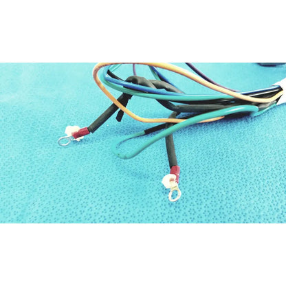 A bundle of multi-colored insulated connector wire harness cables with red terminals and metal loop ends