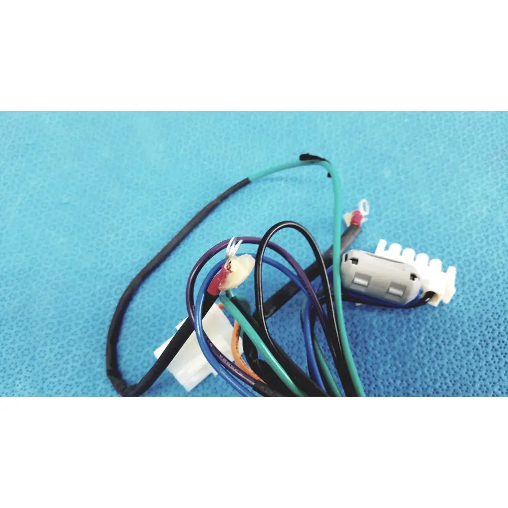 A tangle of multi-colored wires with a white plastic connector in a 4 multi-pin connector wire harness cables