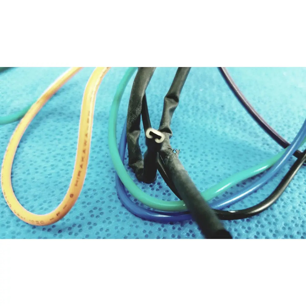 A bundle of colorful yellow green blue and black flexible tubing in 4 multi-pin connector wire harness cables