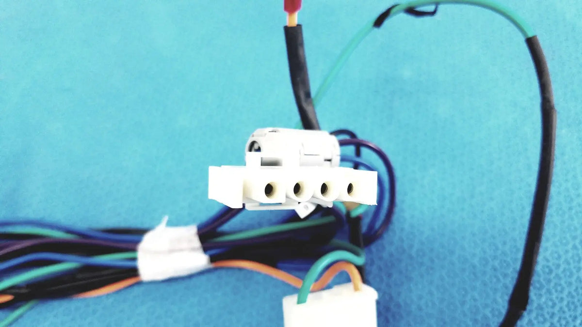 White plastic multi-pin connector wire harness with multiple circular ports and attached multi-colored wire harness cables