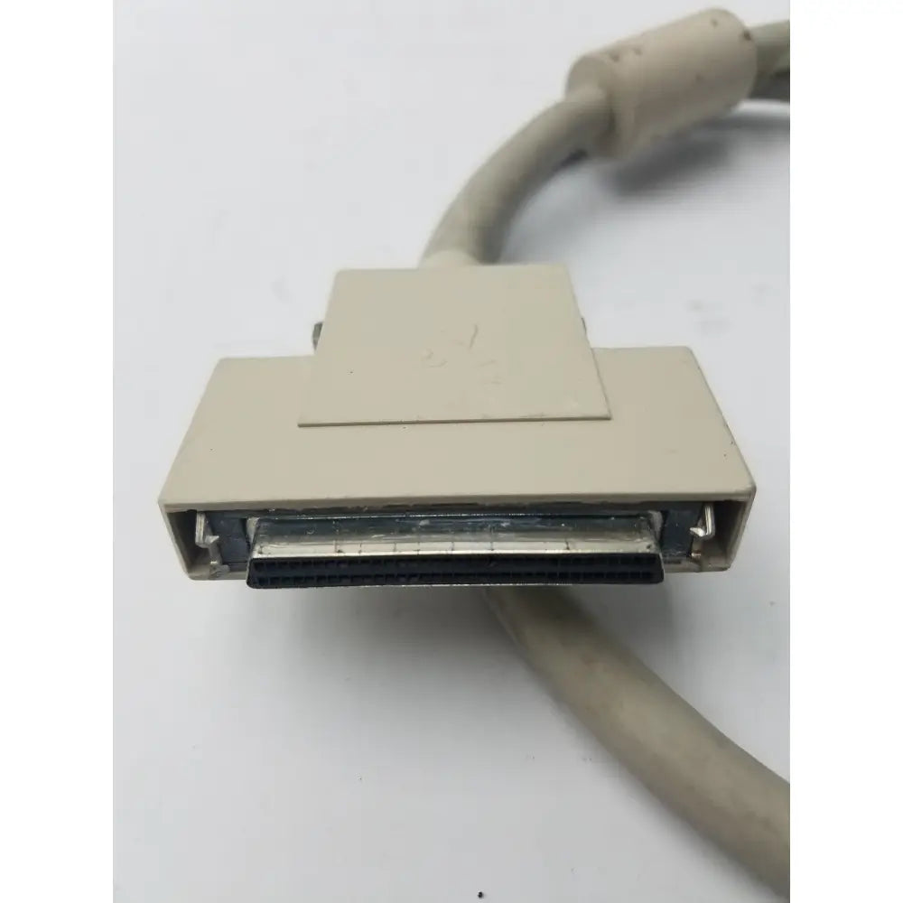 Beige plastic 50-pin male hard drive db-25 connector with metallic contacts and beige cable for scsi-ii connection