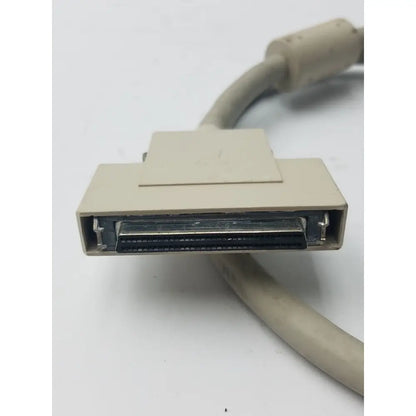 Beige rectangular db-25 male hard drive connector with metallic pins and matching cable for hard drive use