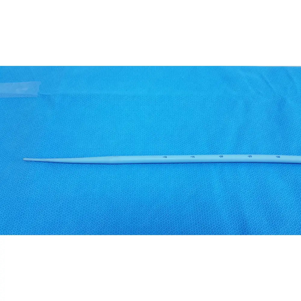 A white slender maloney tapered esophageal bougie 42fr made with tungsten-filled material and measurement markings