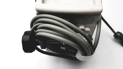 Gray coiled cable with black connector attached to a white device in a 60 count medical isolation gown level 2 product image