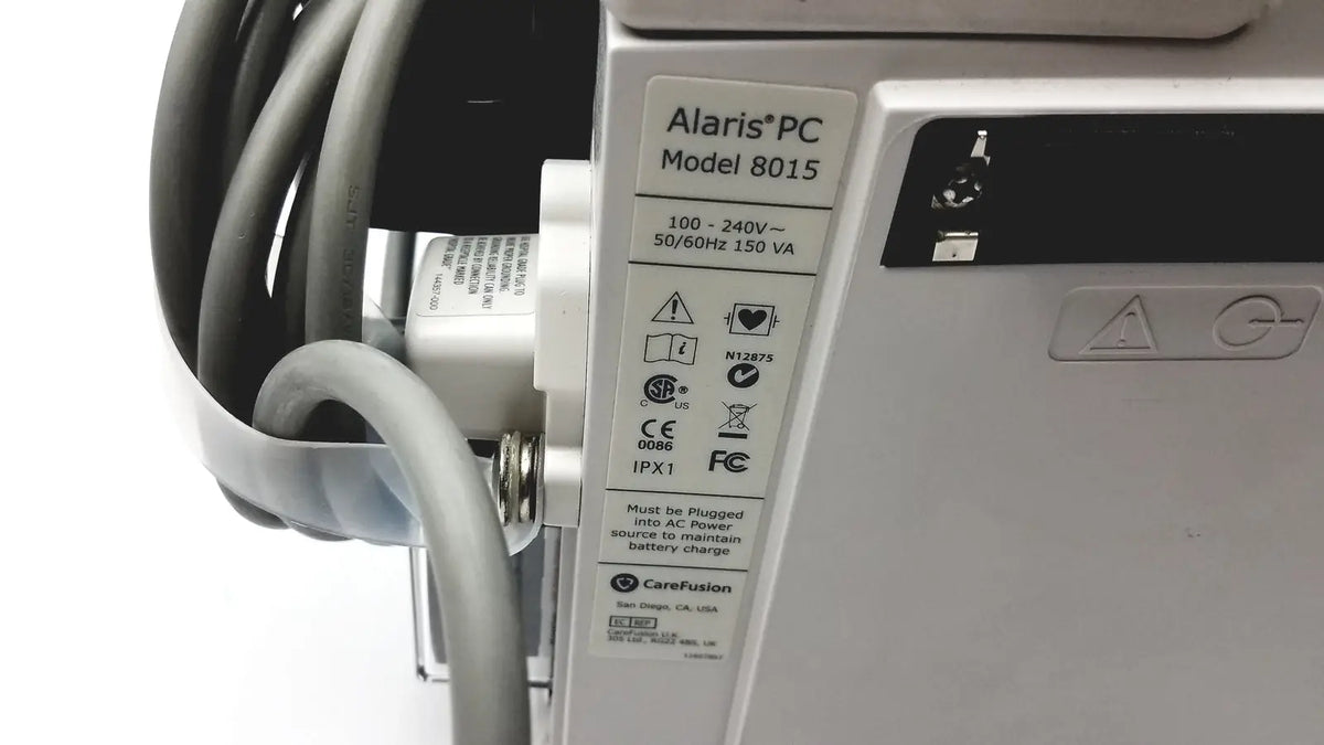 Silver alaris pc model 8015 medical device with labeled specifications shown beside 60 count medical isolation gown level 2