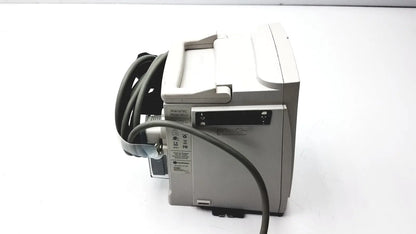 Gray alarms medical monitor with coiled black cable and small screen shown with 60 count medical isolation gown level 2 product