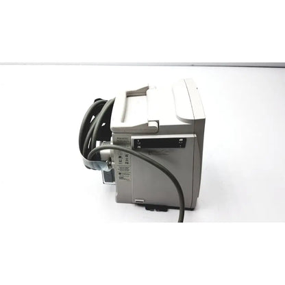Gray alarms medical monitor with coiled black cable and small screen shown with 60 count medical isolation gown level 2 product