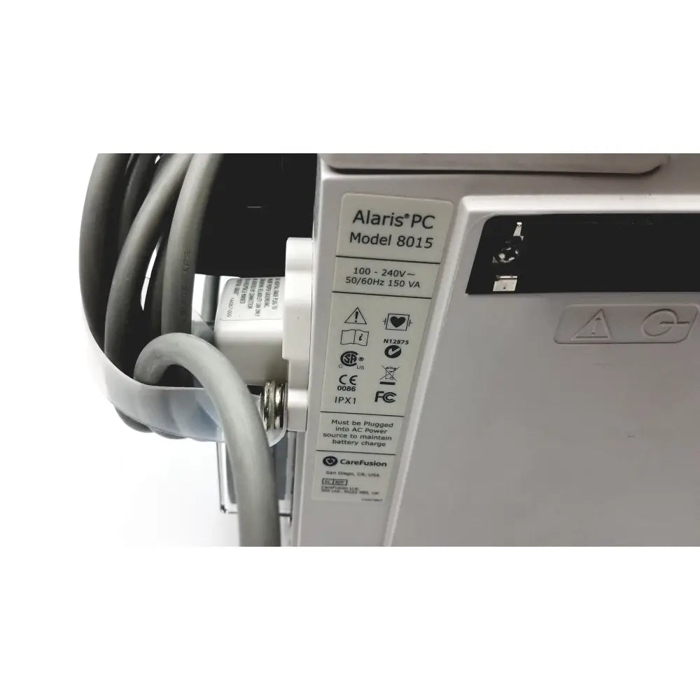 Silver alaris pc model 8015 medical device with labeled specifications shown beside 60 count medical isolation gown level 2