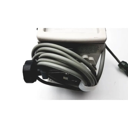 Gray coiled cable with black connector attached to a white device in a 60 count medical isolation gown level 2 product image