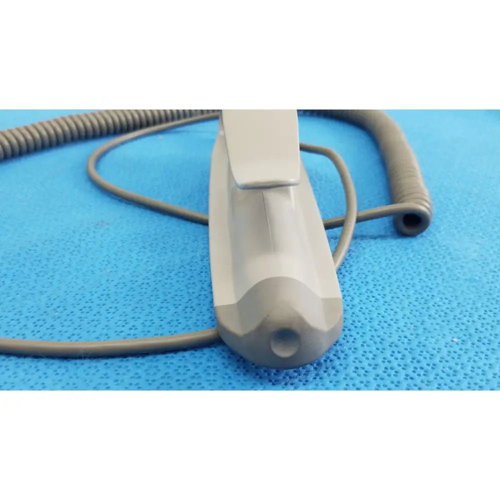Gray plastic remote control with coiled cord for patient lift chair featuring two functions for patient lift use