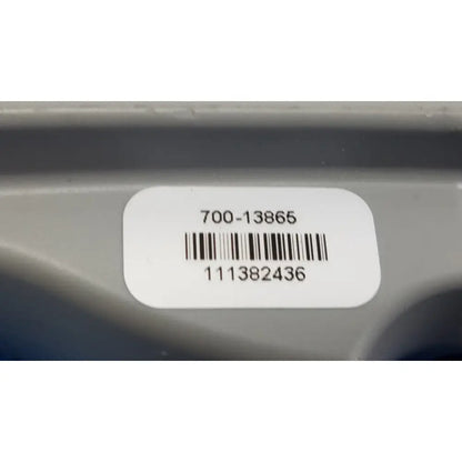 White rectangular label with black barcode on gray plastic surface of remote control for patient lift chair model 700-13865