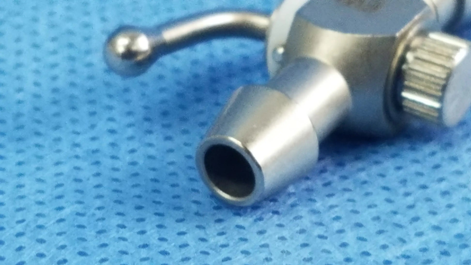 Silver metallic 75u universal stopcock with textured knob and rounded handle for fluid management in OBGYN and urology