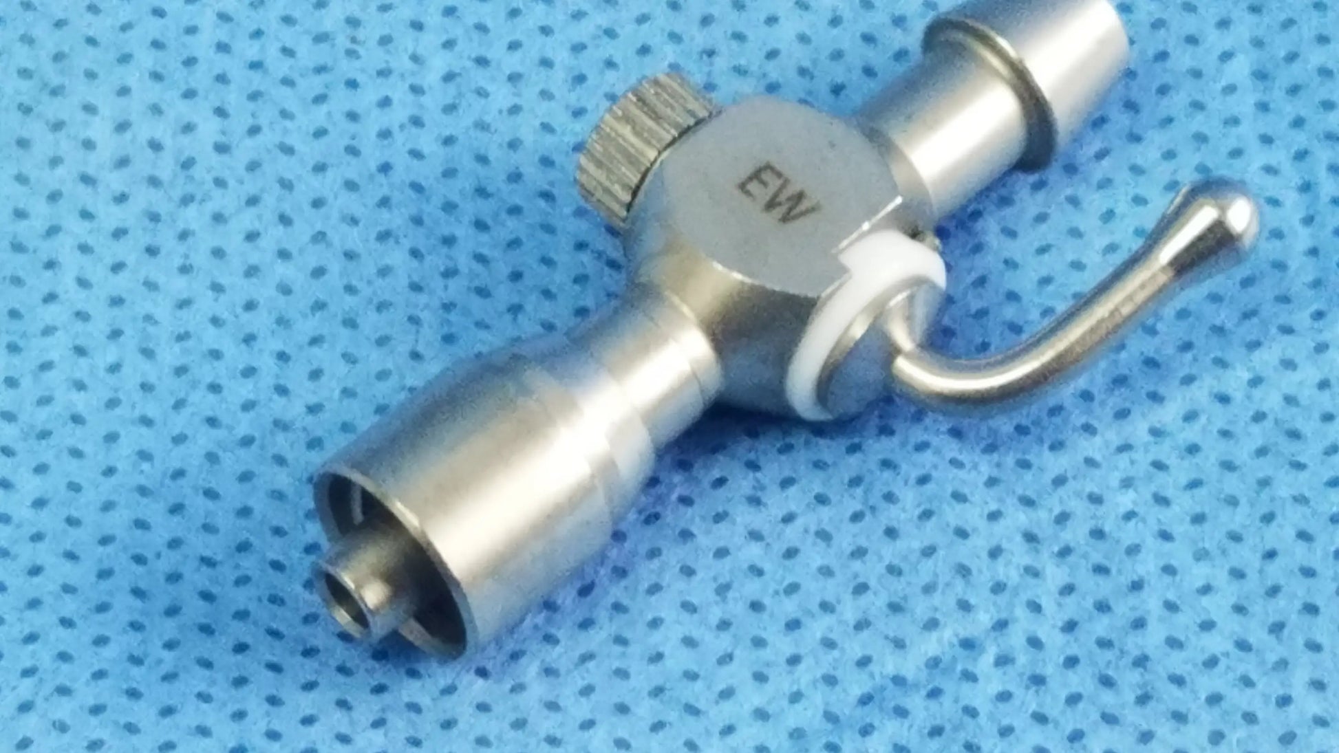 Stainless steel 75u universal stopcock with knurled adjustment knob and curved handle for fluid management in oBGYN and urology