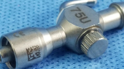 Silver metallic 75u universal stopcock with luer lock textured adjustment knob for fluid management in surgery