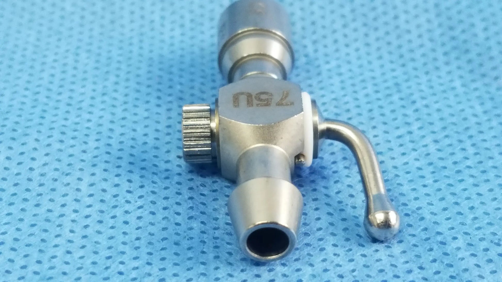Stainless steel 75u universal stopcock with knurled adjustment knob and curved spout for fluid management