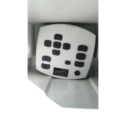 White plastic remote control with black buttons and signature logo for abbott whitestar signature phacoemulsification system