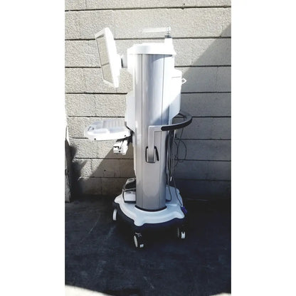 Silver and white abbott whitestar signature phacoemulsification system with monitor, adjustable tray, and wheeled base