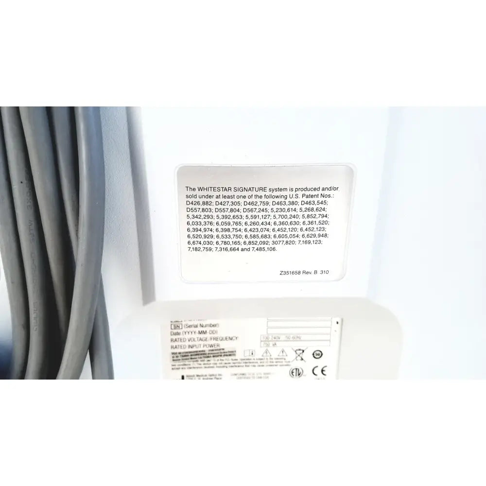 White rectangular label with black text displaying patent numbers on the back of abbott whitestar signature phacoemulsification system