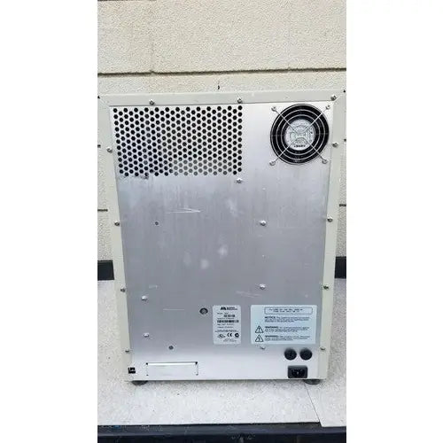 Silver metallic industrial fan unit with perforated panel on the back of the abi prism 7000 sequence detection system