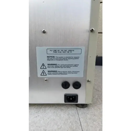 Back side of silver metallic abi prism 7000 sequence detection system with black circular ports and power input socket