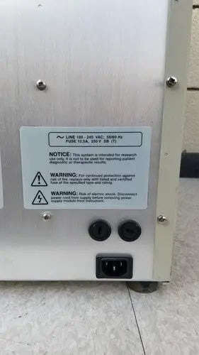 Back side of silver metallic abi prism 7000 sequence detection system with black circular ports and power input socket