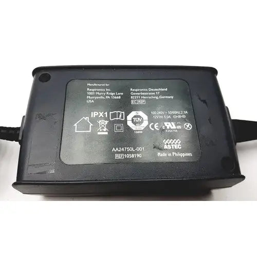 Black plastic power adapter aa24750l-001 with matte finish and printed label for respironics astec series product