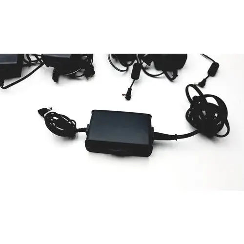 Black rectangular ac adapter aa24750l-001 with coiled cables for respironics astec series respiratory devices