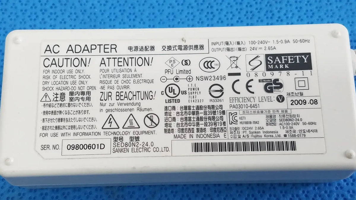 White plastic power adapter sed80n2-24 with printed specifications and safety markings for 24v 2.65a output
