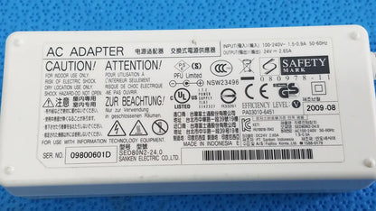 White plastic power adapter sed80n2-24 with printed specifications and safety markings for 24v 2.65a output