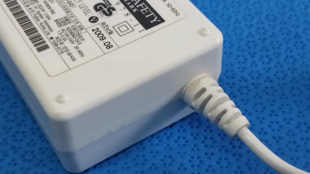 White plastic power adapter sed80n2-24 with coiled white cable and safety certification label for 24v 2.65a output