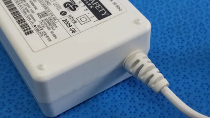 White plastic power adapter sed80n2-24 with coiled white cable and safety certification label for 24v 2.65a output