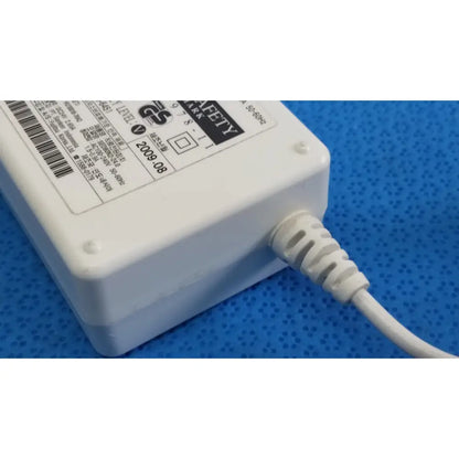 White plastic power adapter sed80n2-24 with coiled white cable and safety certification label for 24v 2.65a output