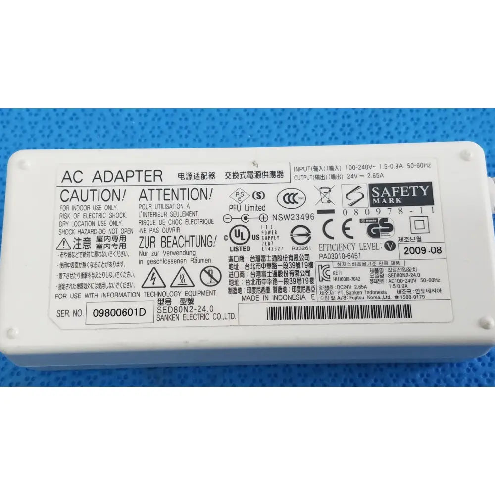 White plastic power adapter sed80n2-24 with printed specifications and safety markings for 24v 2.65a output
