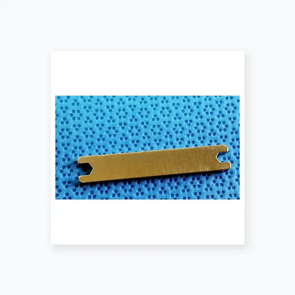 Silver metal medical equipment with rectangular body and notched ends for sterilization tray in dental implant kit