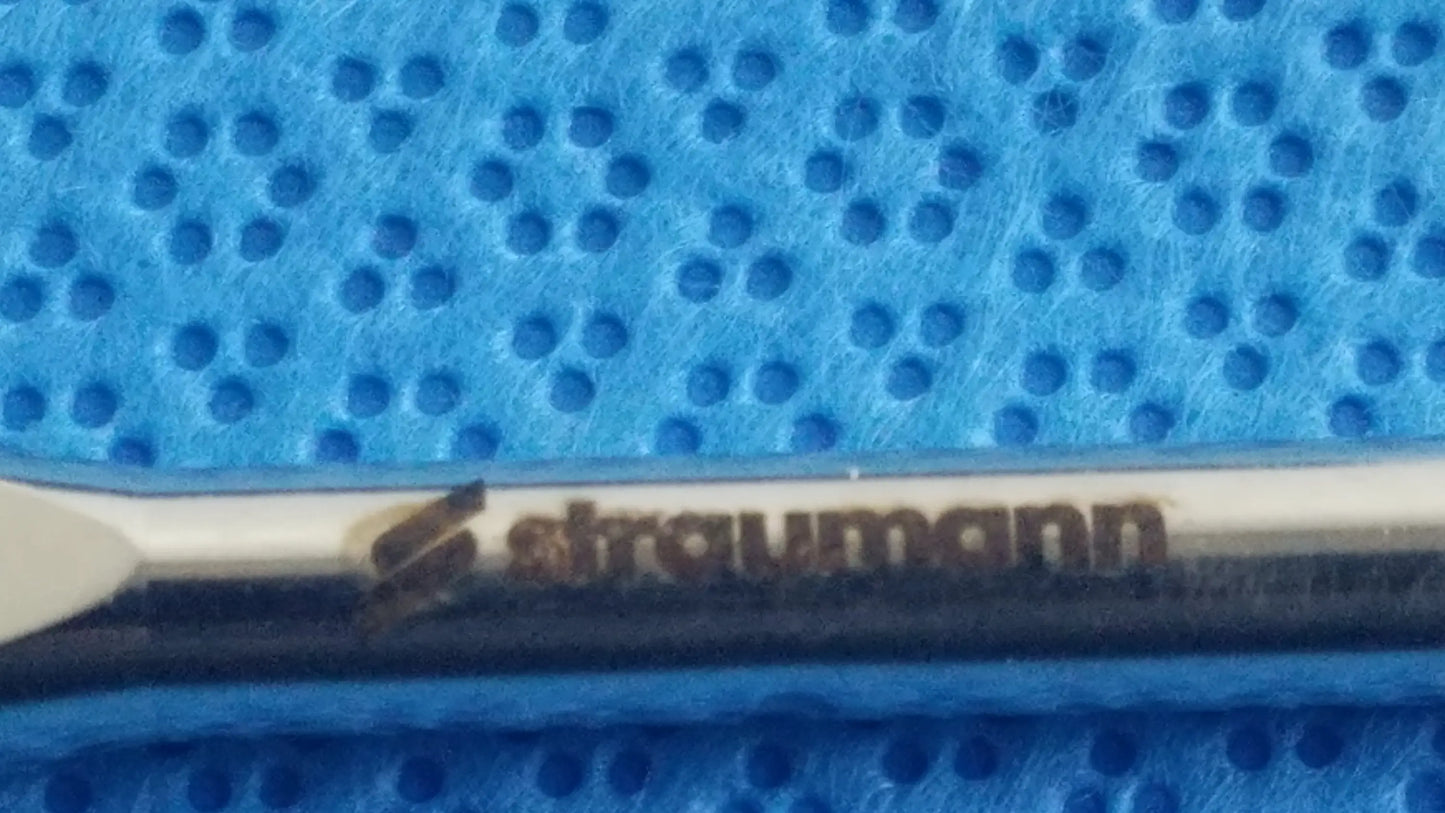 Silver-colored straumann dental implant screw with polished finish and branding in ace 765-1001 sterilization tray medical equipment