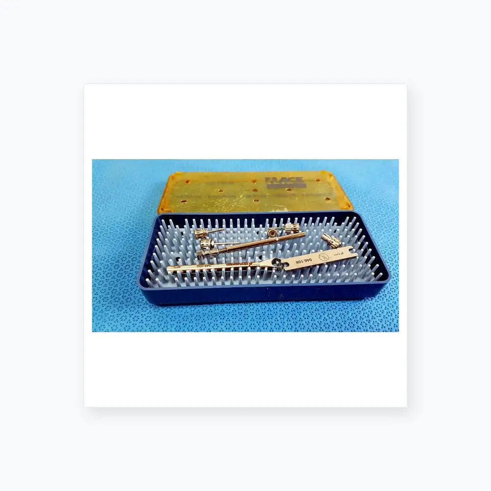 Ace 765-1001 sterilization tray with silver metal dental implant tools and clear plastic lid for medical equipment use