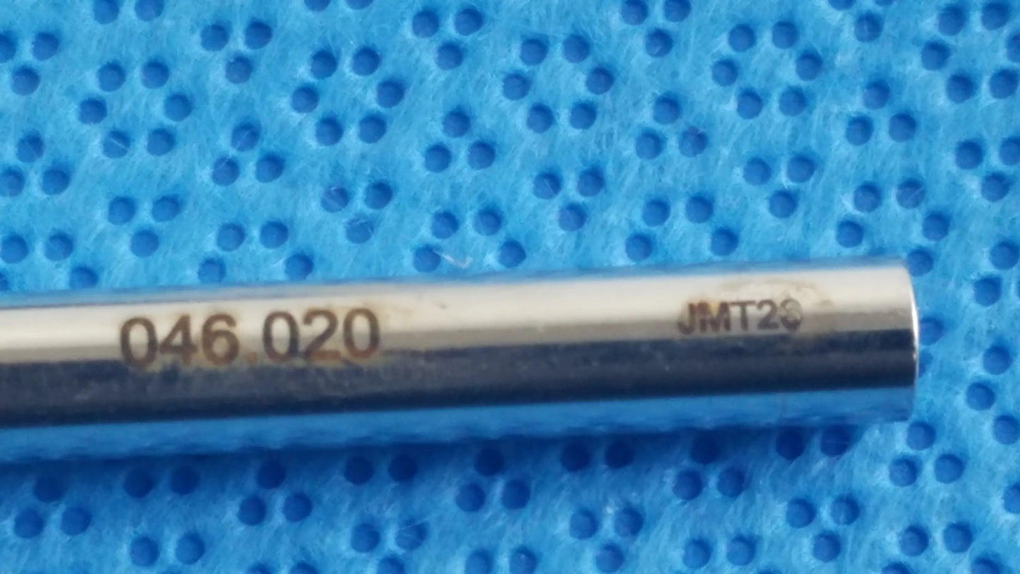 A sleek metallic cylindrical tool with engraved markings in the ace 765-1001 sterilization tray for dental implant use