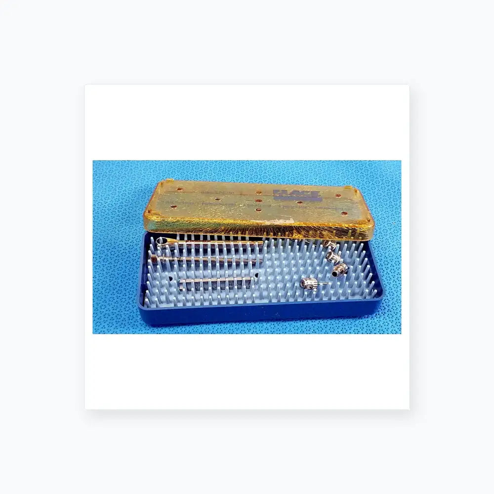 Blue plastic sterilization tray with gold lid containing organized metal dental implant instruments and components for medical equipment
