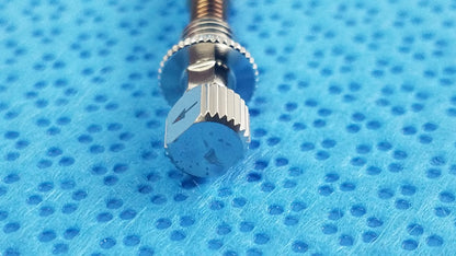 Silver-toned watch crown with hexagonal textured head and ridged edges featured in ace 765-1001 sterilization tray dental implant kit