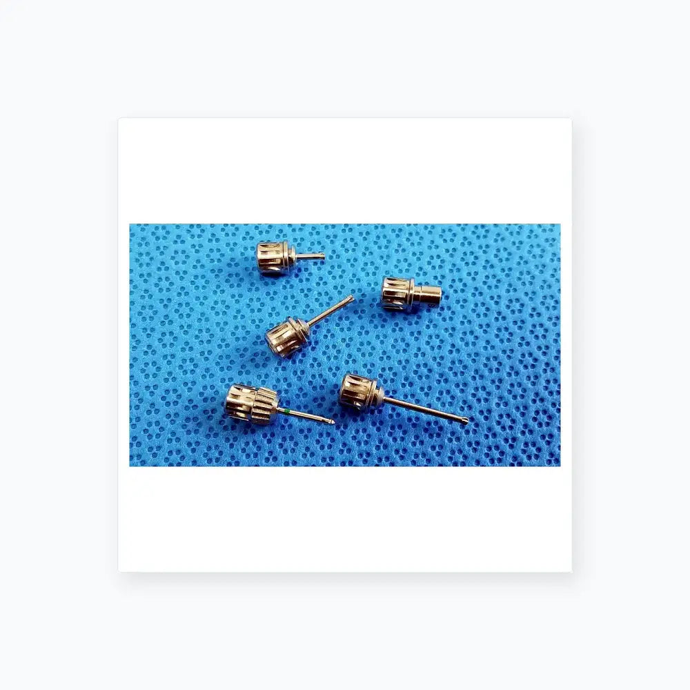 Silver-colored metal watch crown adjusters with textured gear-like surface and slender stems in ace 765-1001 sterilization tray for dental implant medical equipment
