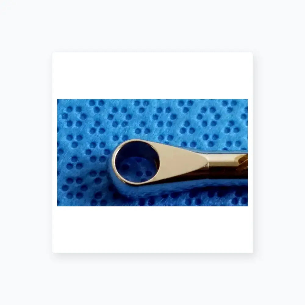 Shiny chrome-plated metal nose hair trimmer with sleek tapered design and rounded handle in dental implant sterilization tray