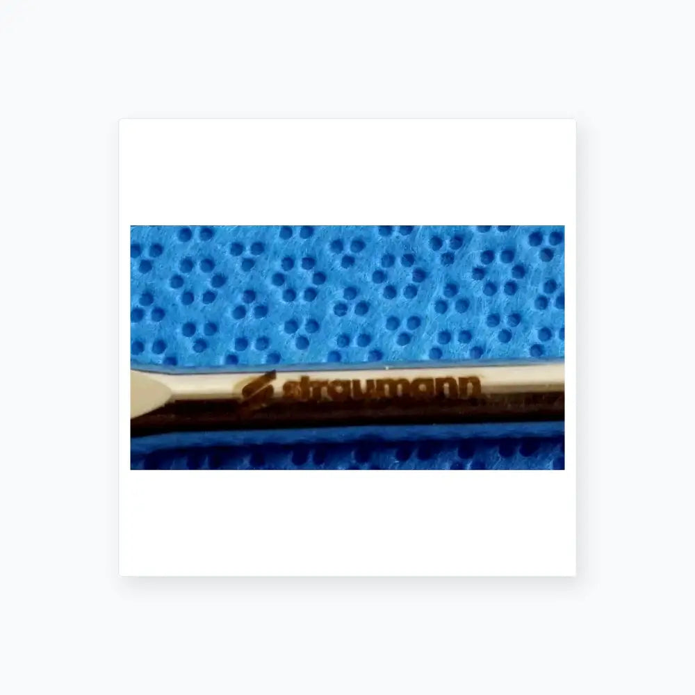 Silver-colored straumann dental implant screw with polished finish and branding in ace 765-1001 sterilization tray medical equipment
