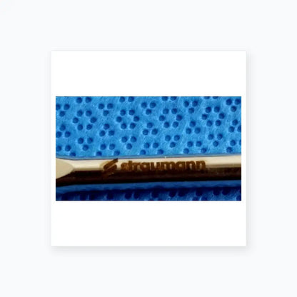 Silver-colored straumann dental implant screw with polished finish and branding in ace 765-1001 sterilization tray medical equipment