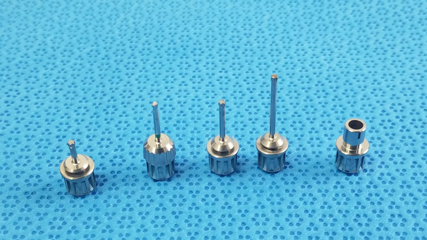 Set of five metallic dental implant screwdrivers with textured handles in ace 765-1001 sterilization tray medical equipment