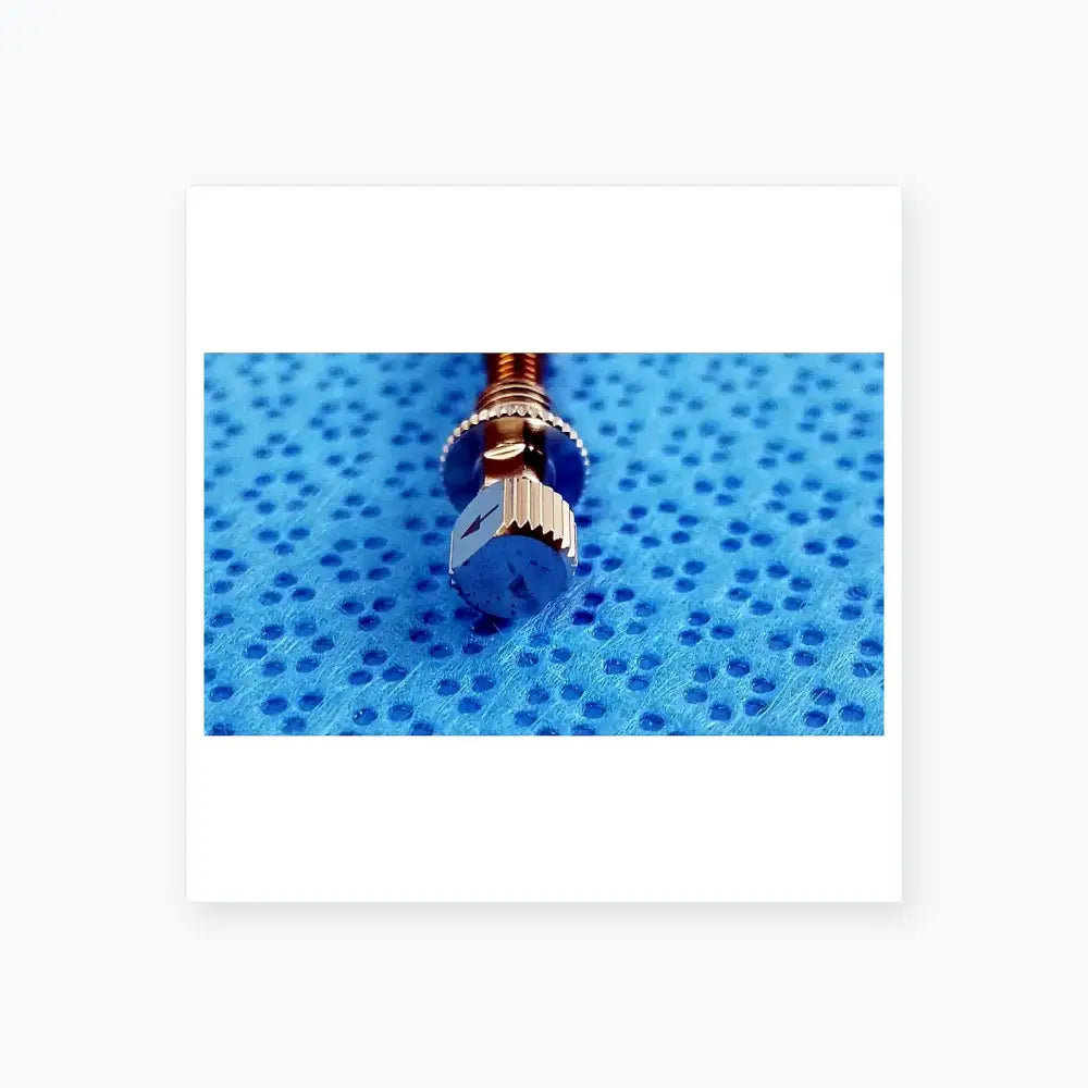 Silver-toned watch crown with hexagonal textured head and ridged edges featured in ace 765-1001 sterilization tray dental implant kit